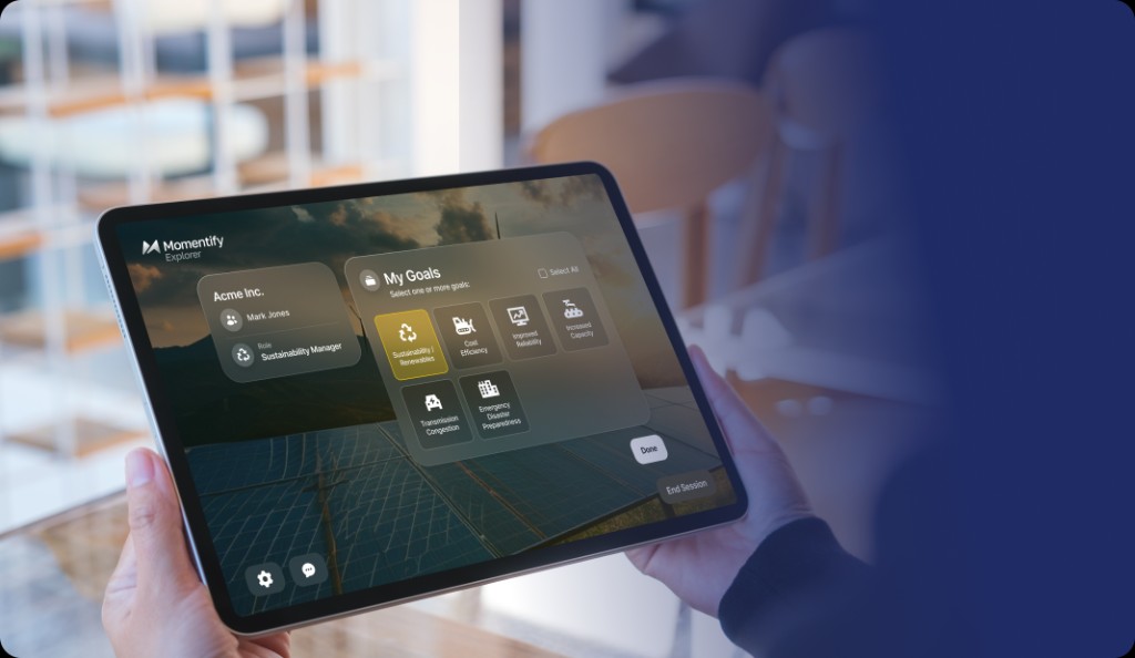 Person holding a tablet showing the Momentify Explorer app with goals and a solar farm background